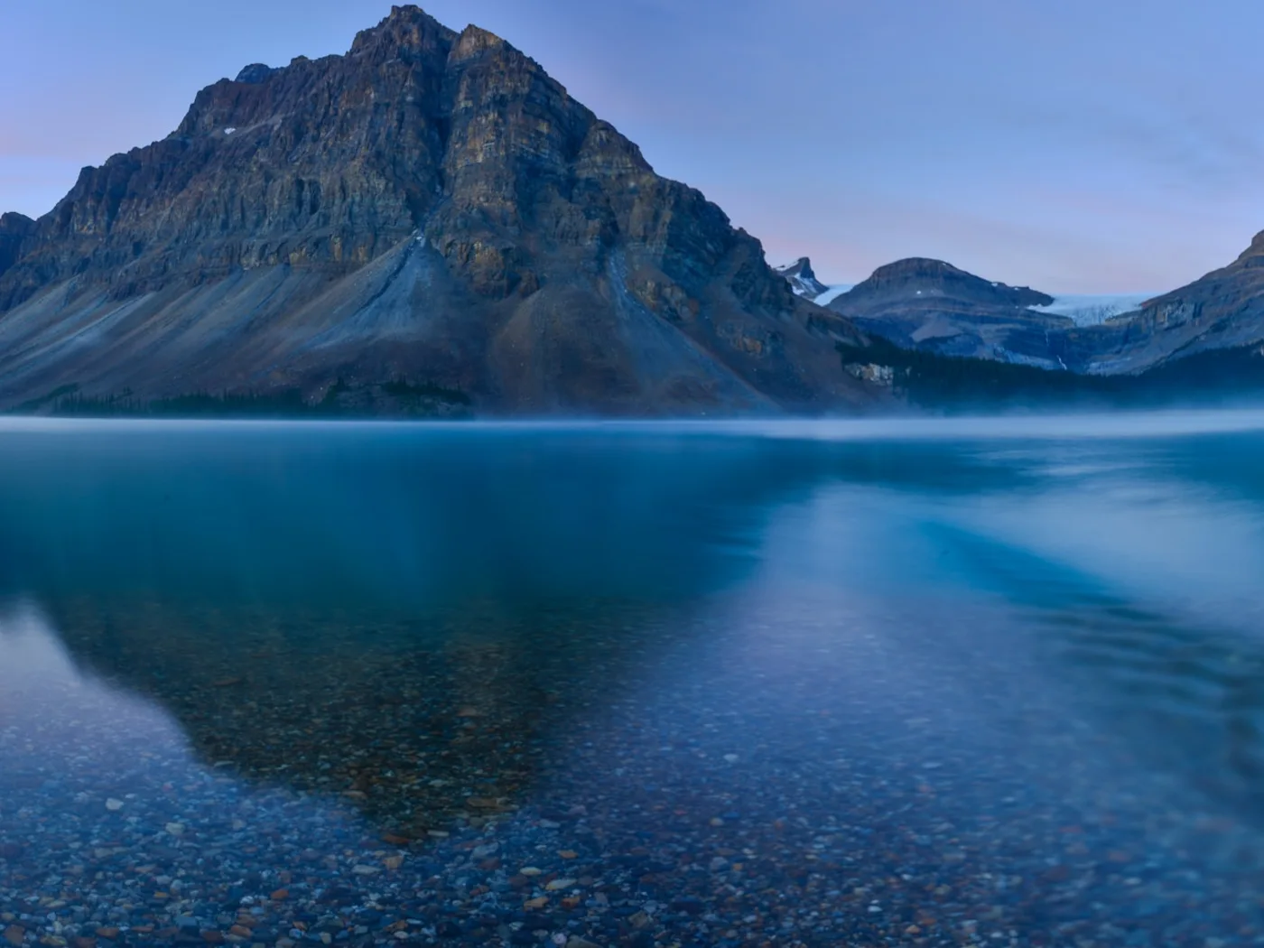 Bow Lake and the Canadian Rockies in blue morning light