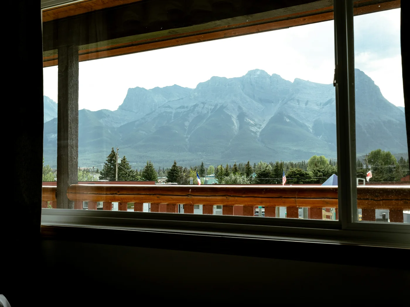 Canadian Rockies seen through a hotel room window in Canmore