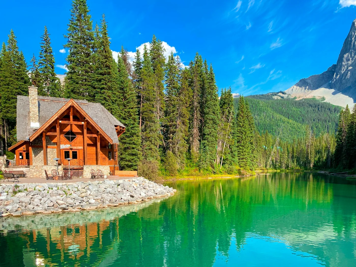 A timber cabin beside the turquoise water of Emerald Lake